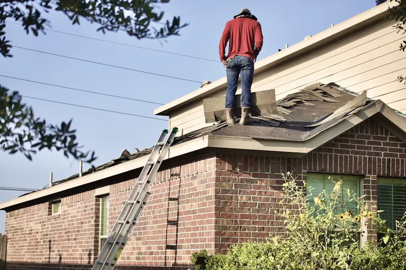 Professional roofer working on a residential roof in Fort Irwin